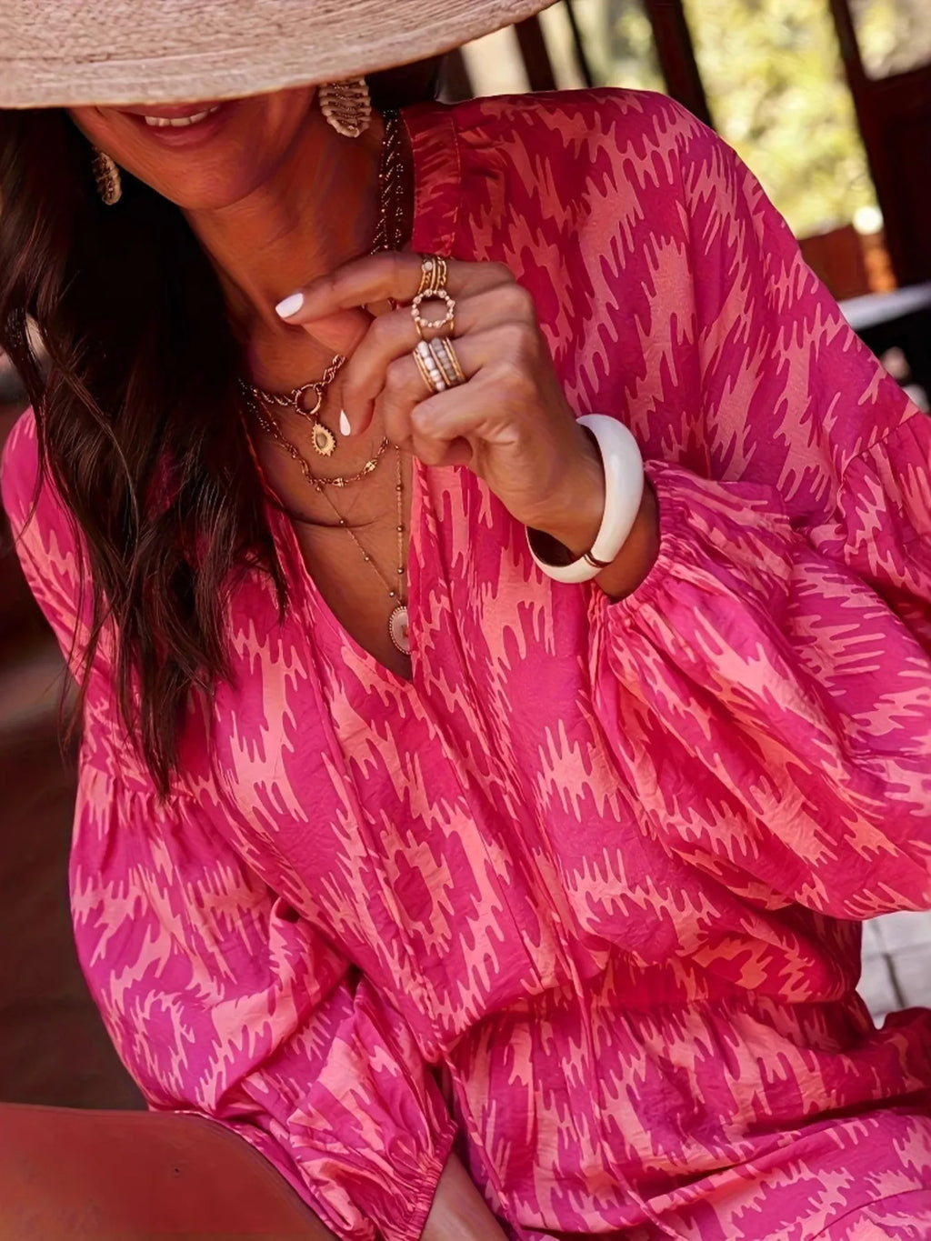 Close-up of a woman wearing a Printed Balloon Sleeve Top and Shorts Set with balloon sleeves and layered jewelry.