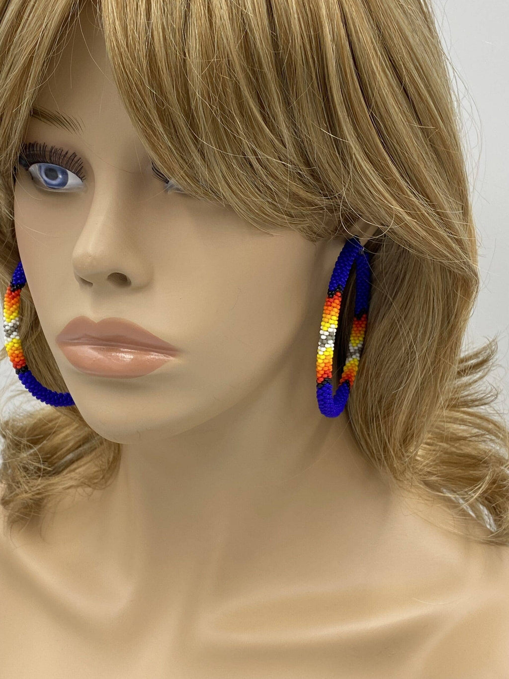 Handmade Native Style 3 Inch Hoop Earrings with Czech Seed Beads - Deep Blue worn by a mannequin.