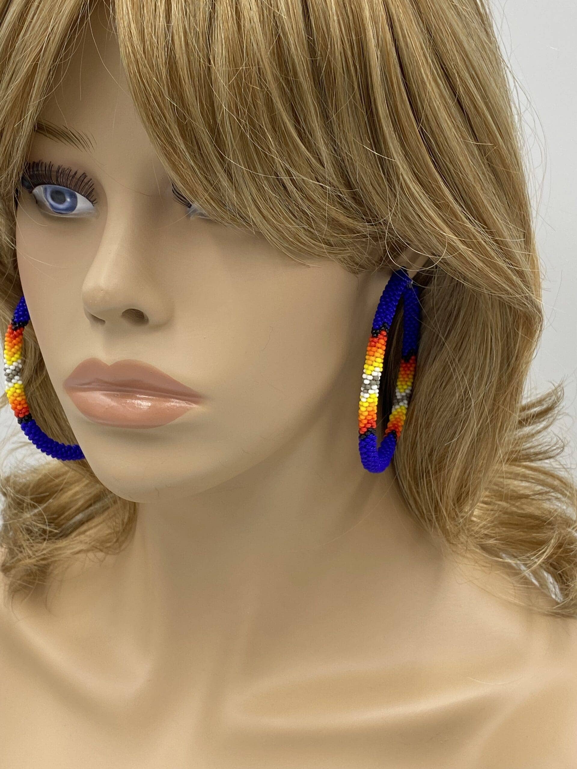 Handmade Native Style 3 Inch Hoop Earrings with Czech Seed Beads - Deep Blue worn by a mannequin.