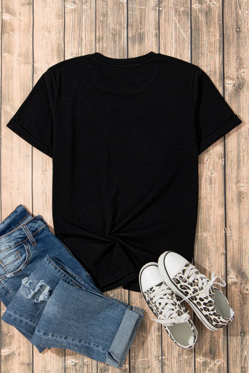 Rhinestone Round Neck Short Sleeve T-Shirt styled with distressed jeans and leopard print sneakers on a wooden surface.