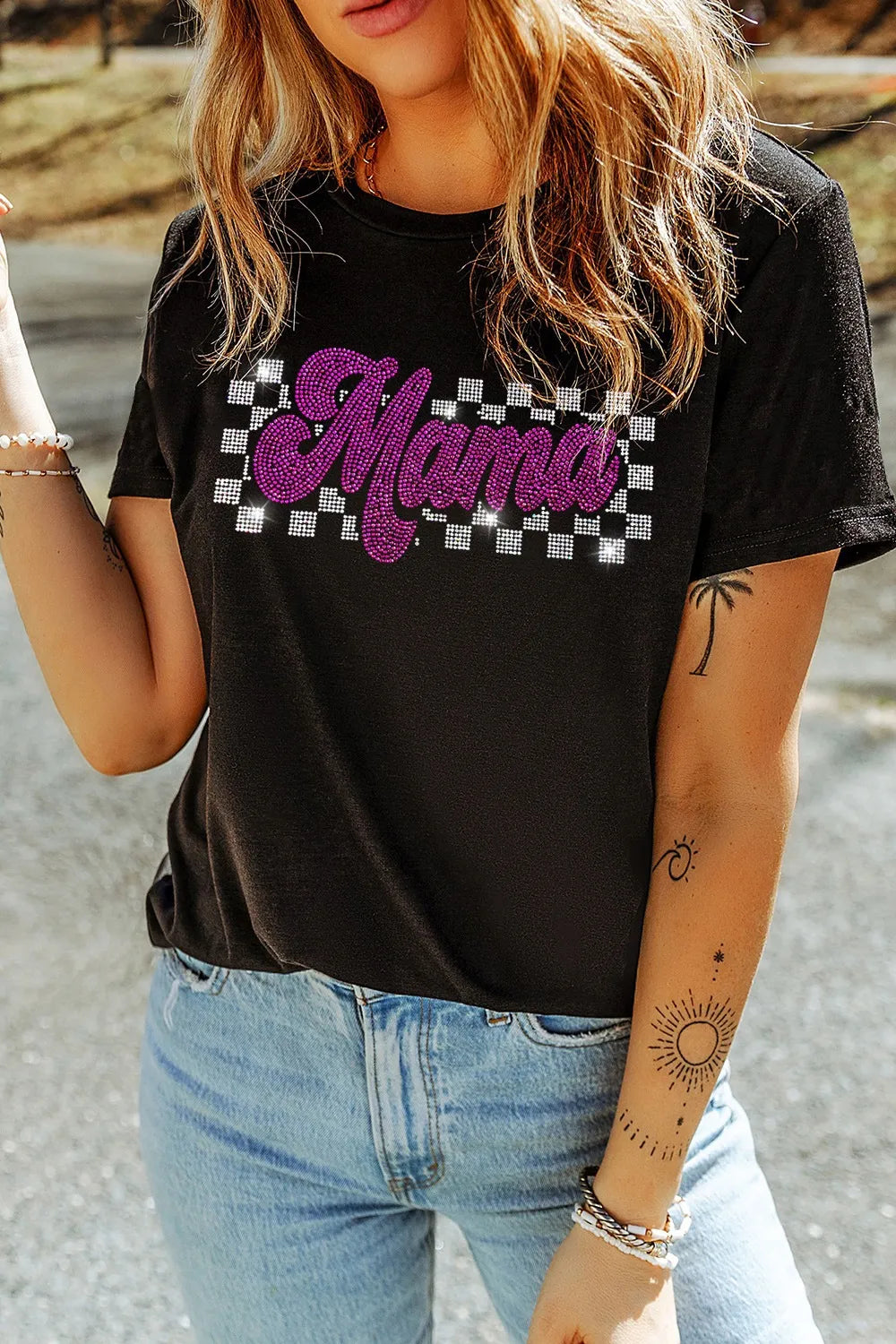 MAMA Rhinestone Letter Round Neck T-Shirt worn by a model against an outdoor background, showcasing stylish rhinestone details.