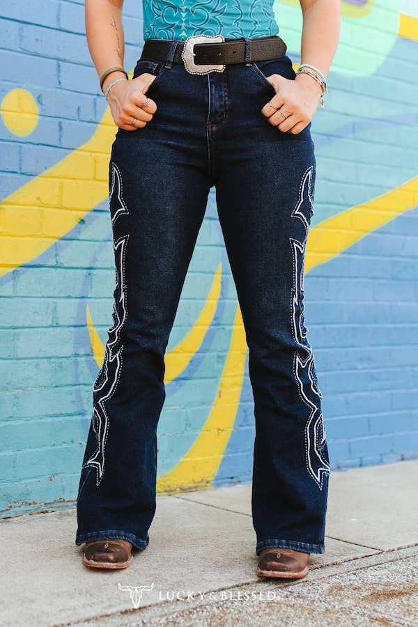 Plus Dark Wash Tummy Control Boot Stitch Embroidery Jeans showcased on a model against a colorful mural background.