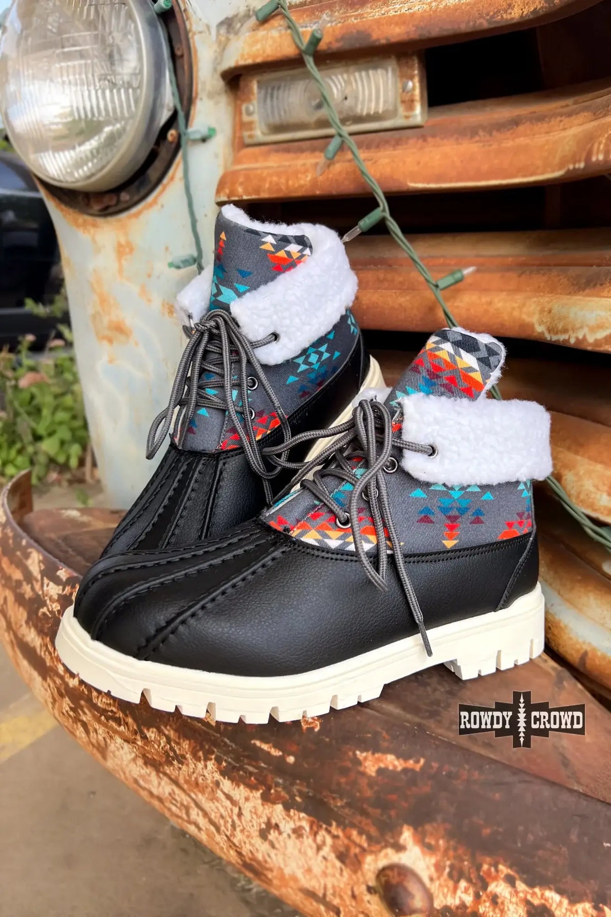 Stylish Down Canyon Duck Boots in black with gray Aztec top and white fur lining, ideal for cold, wet weather.