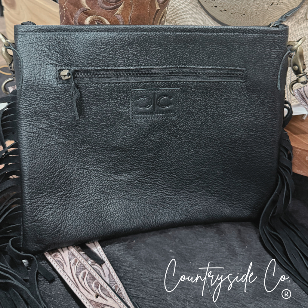 Rodeo Square Cowhide Checkered Purse featuring genuine cowhide with playful fringes and adjustable strap.