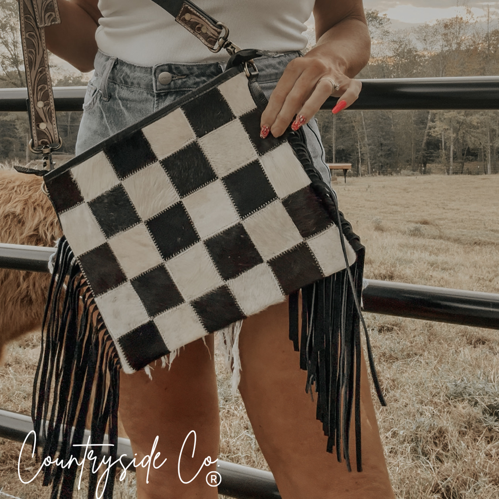 Rodeo Square Cowhide Checkered Purse with fringes, showcasing cowhide checkered pattern and adjustable strap.