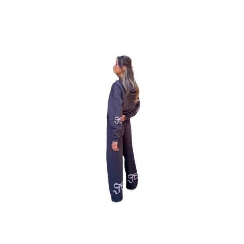 Fleece Hooded Bow Print Sweatsuit worn by a model showcasing the unique bow print and stylish design.
