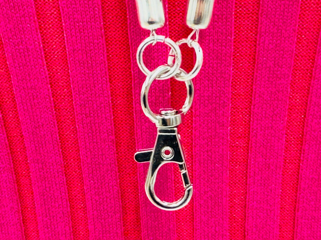Handmade beaded Silvery southwestern woven lanyard with a silver clasp on a vibrant pink background.