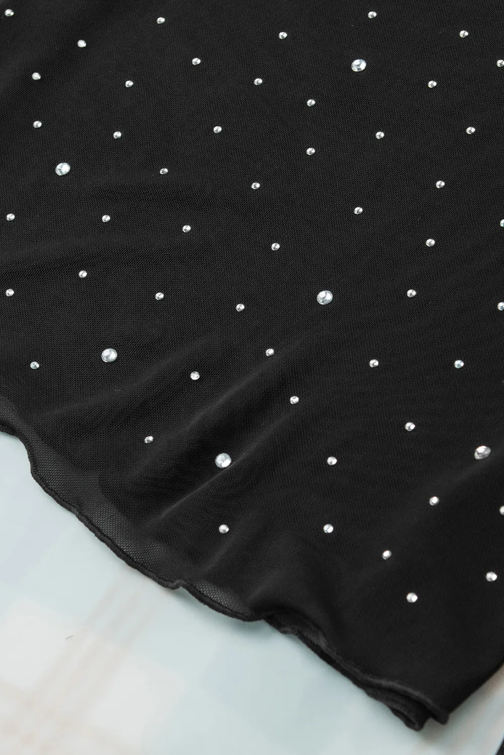 Rhinestone Round Neck Long Sleeve Blouse featuring a black fabric with scattered rhinestones embellishments.