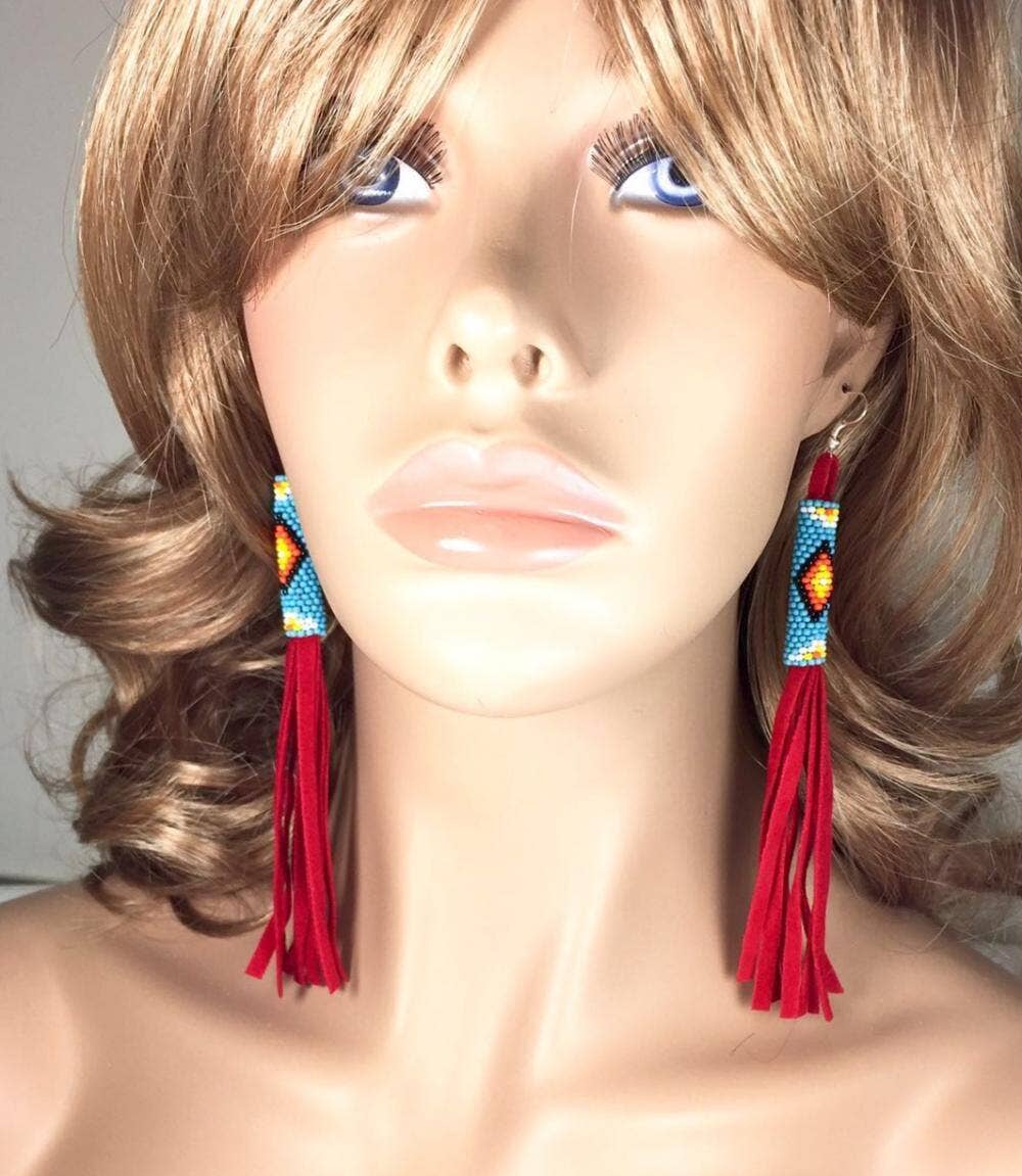 Red Beaded Suede Extra Long Earrings 6 Inch worn by a mannequin, showcasing intricate beadwork and red suede fringe.