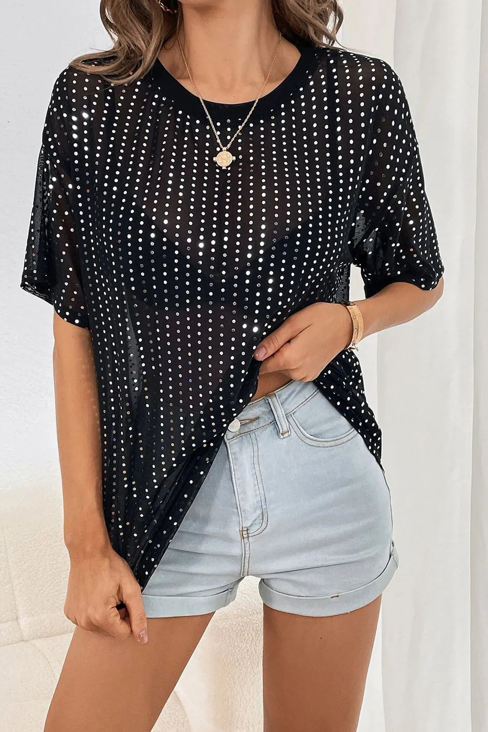 Polka Dot Round Neck Half Sleeve T-Shirt in black sheer fabric with rhinestone details styled with denim shorts.