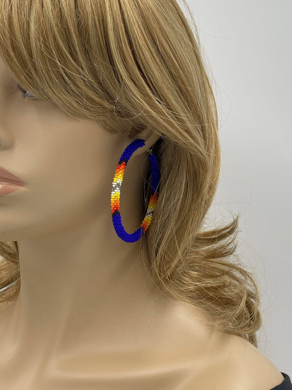 Handmade Native Style 3 Inch Hoop Earrings with Czech Seed Beads - Deep Blue worn by a mannequin against a neutral background.