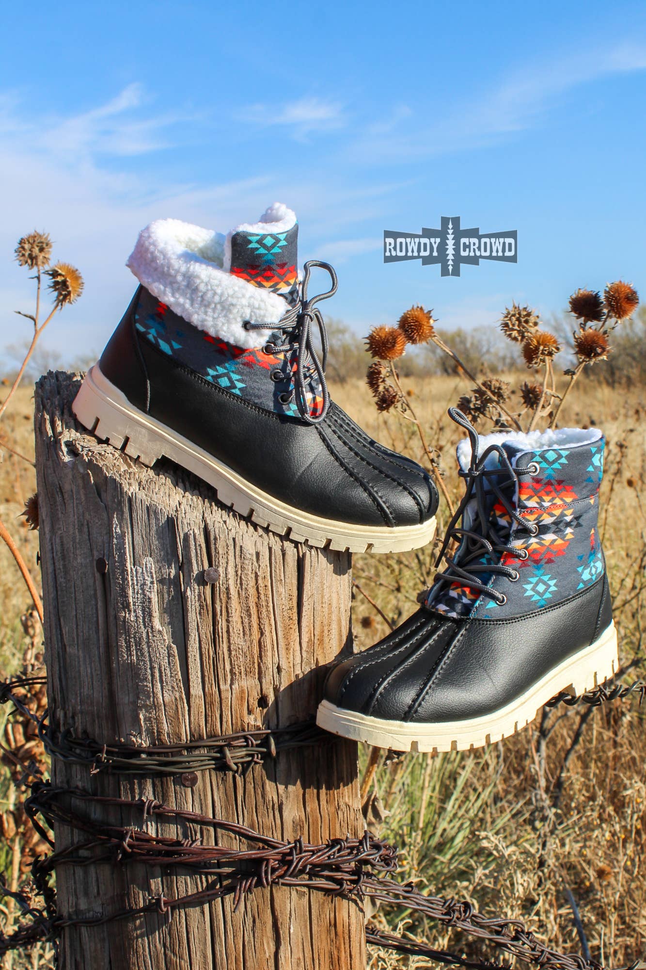 Down Canyon Duck Boots displaying black water-resistant material with gray Aztec top and white fur lining.