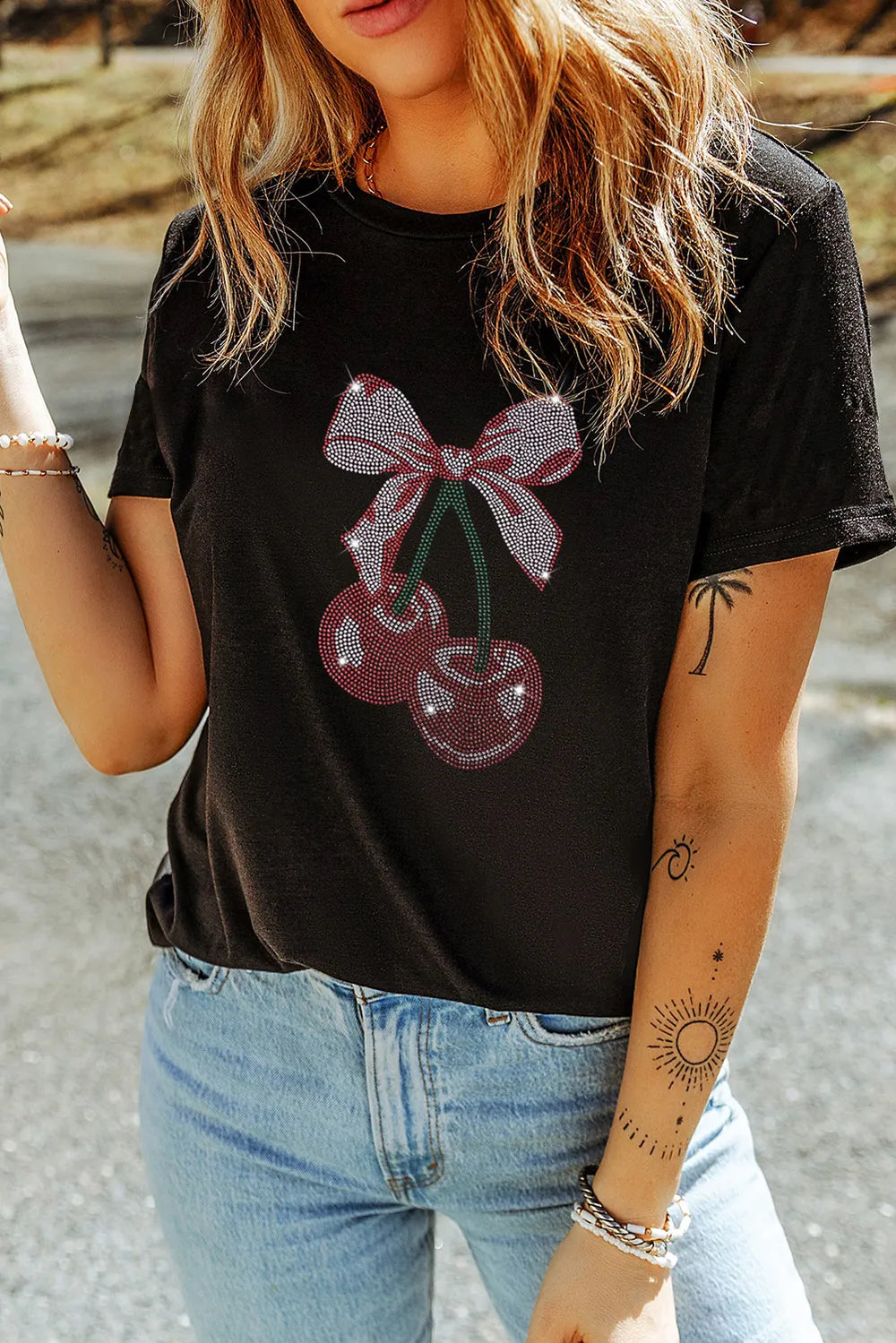 Cherry Graphic Round Neck Short Sleeve T-Shirt featuring a cherry design with a bow on a black tee.