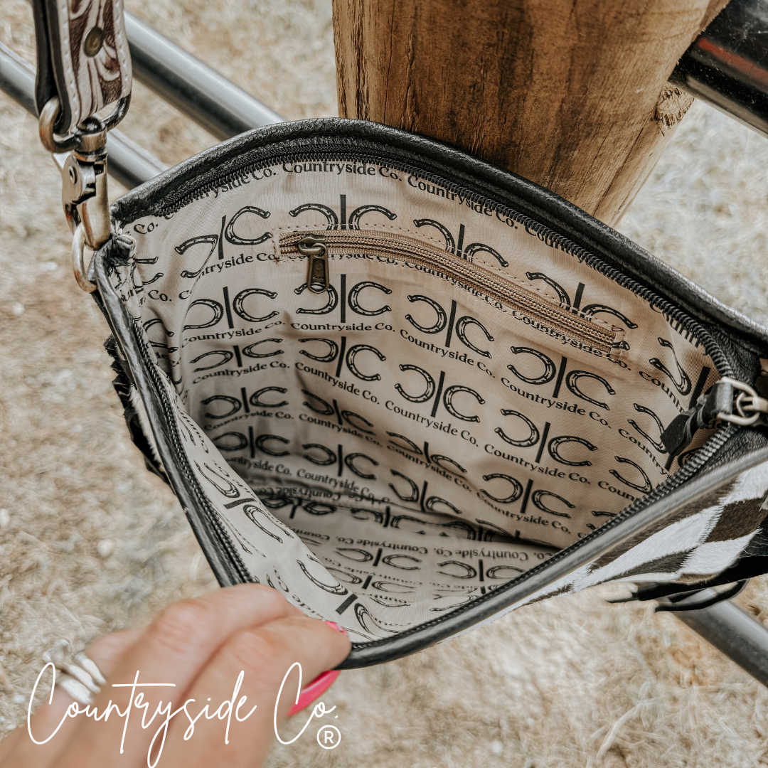 Interior view of the Rodeo Square Cowhide Checkered Purse showcasing its stylish lining and zip pocket.