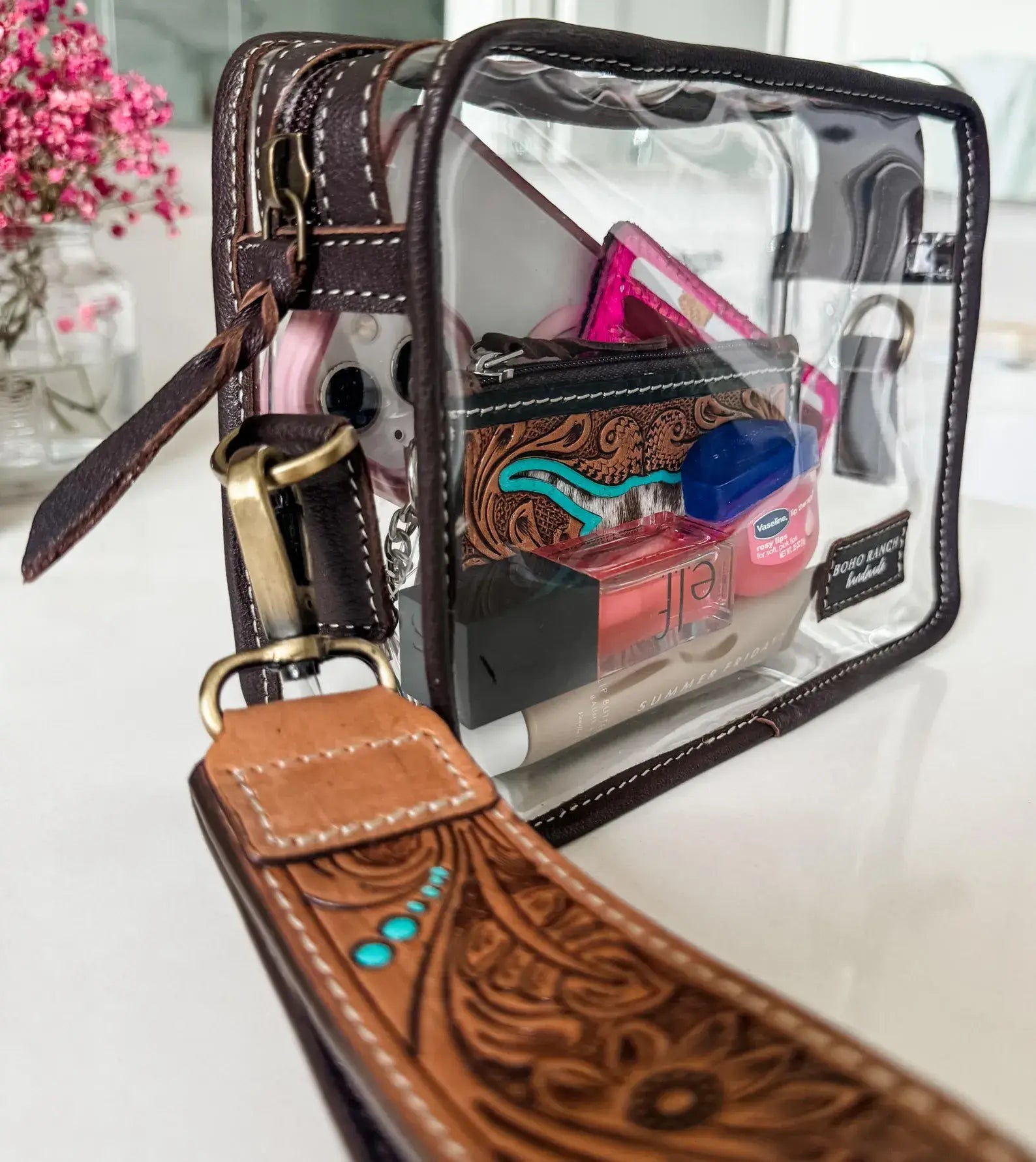 DARLA CLEAR WRISTLET | transparent western purse - game day with clear vinyl and leather strap showcasing inside items.
