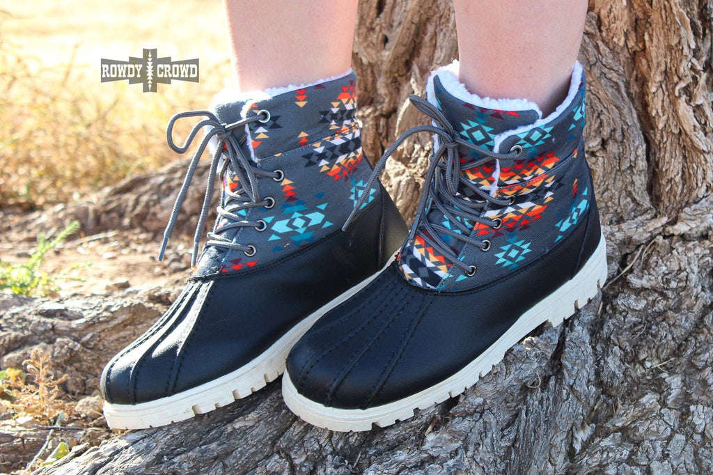 Down Canyon Duck Boots featuring black water-resistant material and a gray Aztec top for cold, wet weather.
