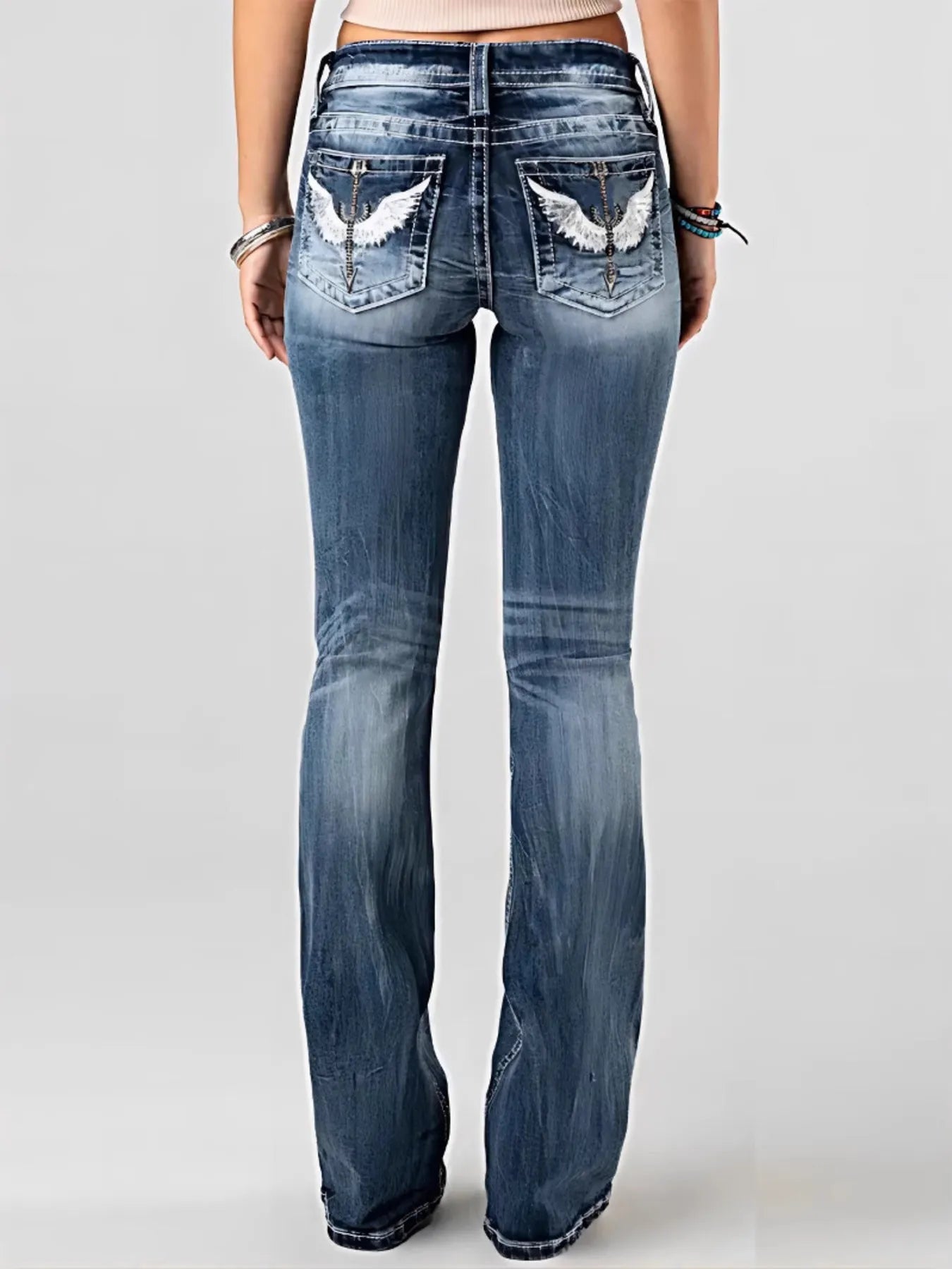Embroidered Washed Bootcut Jeans showcasing detailed back pockets and a classic bootcut silhouette.