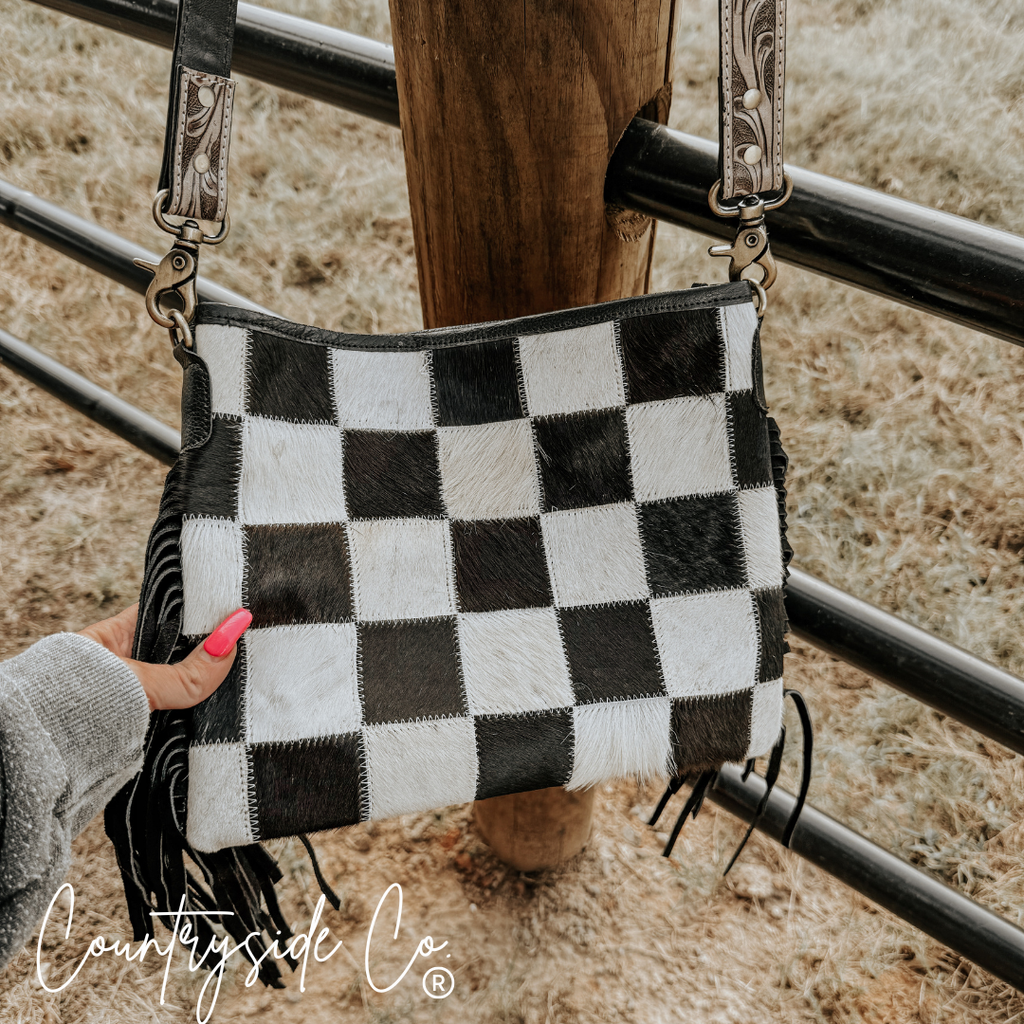 Rodeo Square Cowhide Checkered Purse showcasing a bold checkered design with fringes