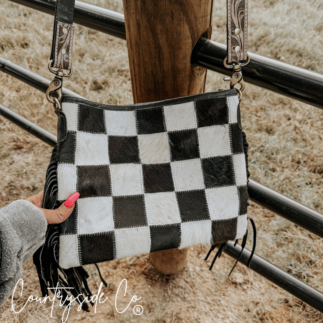 Rodeo Square Cowhide Checkered Purse showcasing a bold checkered design with fringes