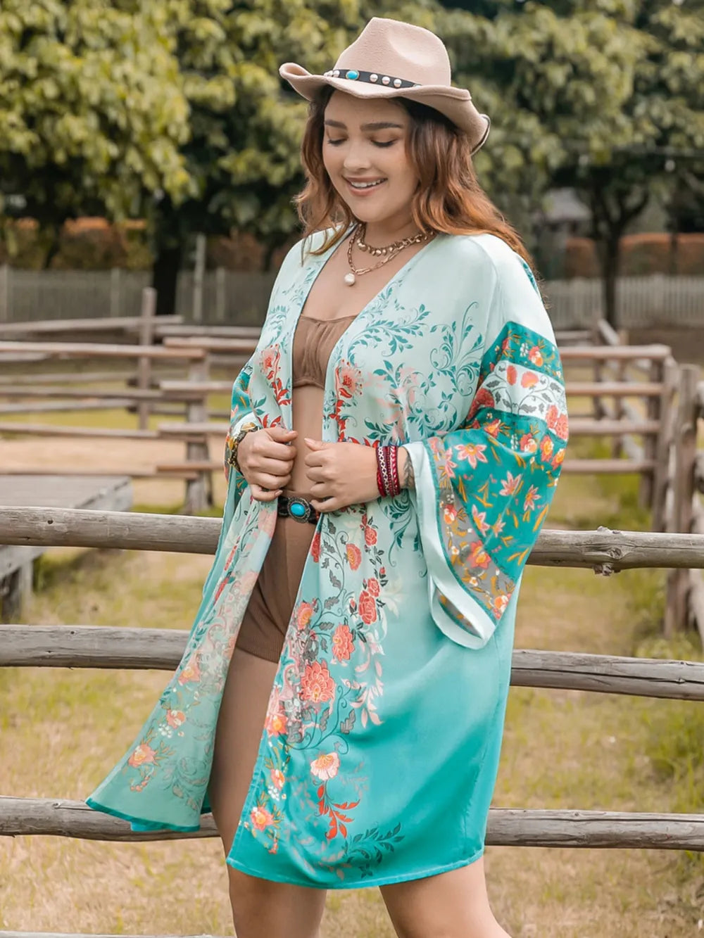 Plus Size Printed Open Front Long Sleeve Cover Up styled over swimwear in a outdoor setting.