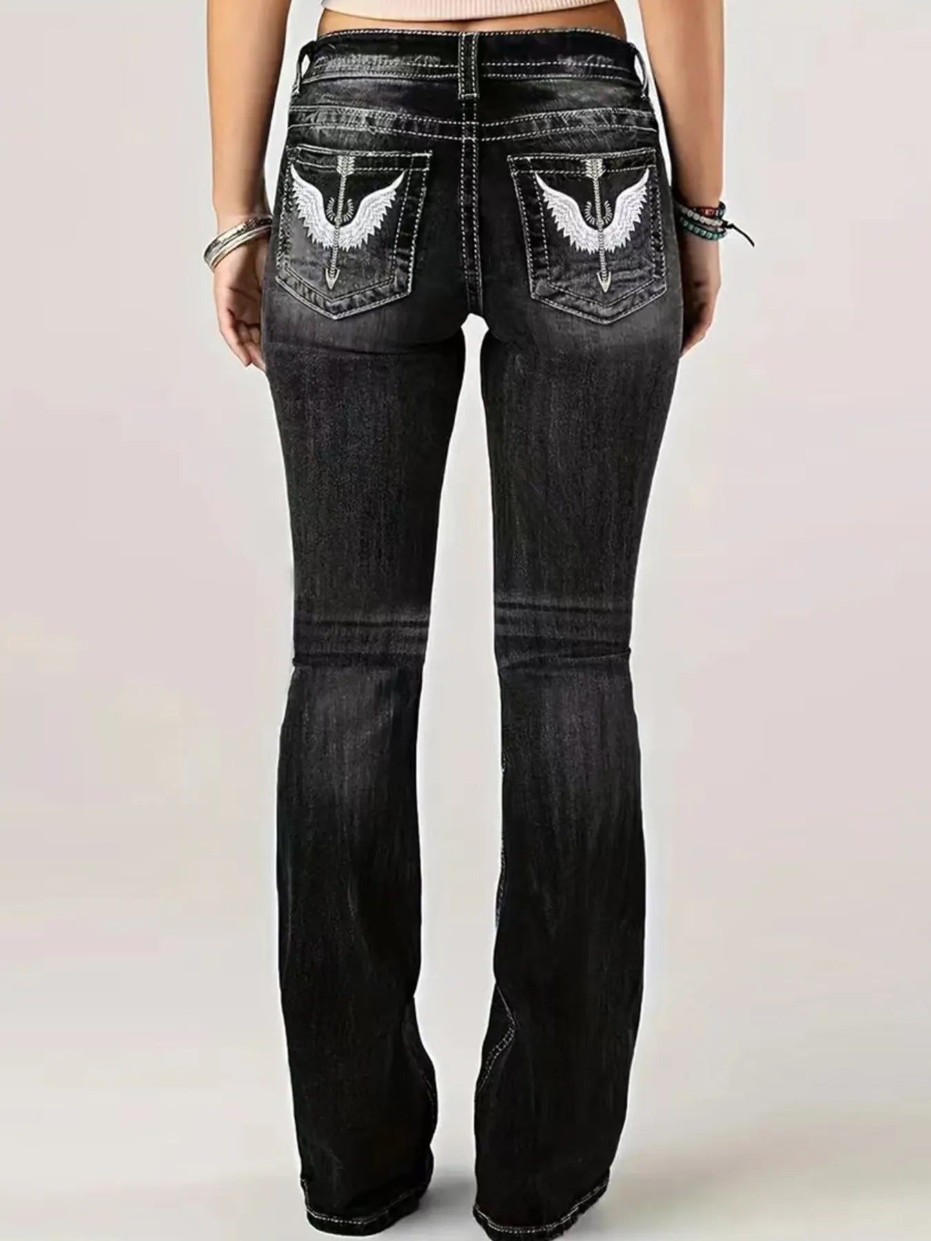 Back view of Embroidered Washed Bootcut Jeans showcasing intricate embroidery and a flattering bootcut silhouette.