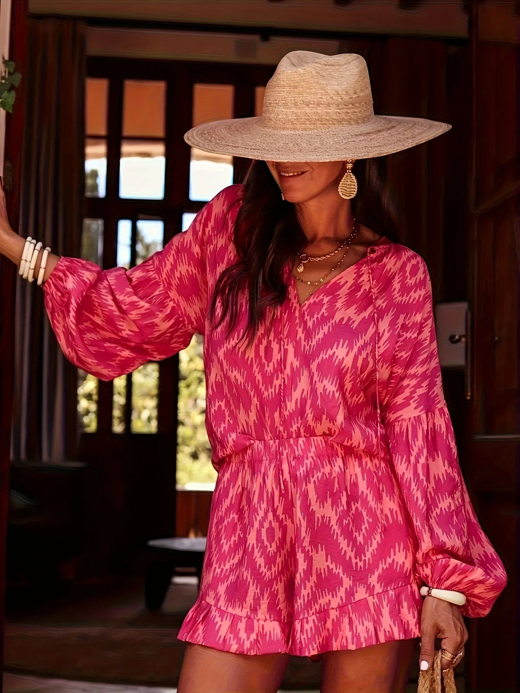 Model wearing a Printed Balloon Sleeve Top and Shorts Set in pink with a straw hat and accessories.