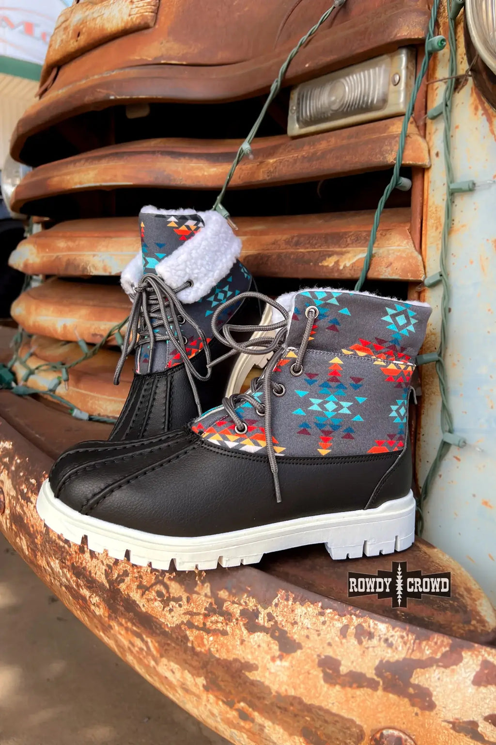 Down Canyon Duck Boots featuring black water-resistant material and gray Aztec top on vintage truck.